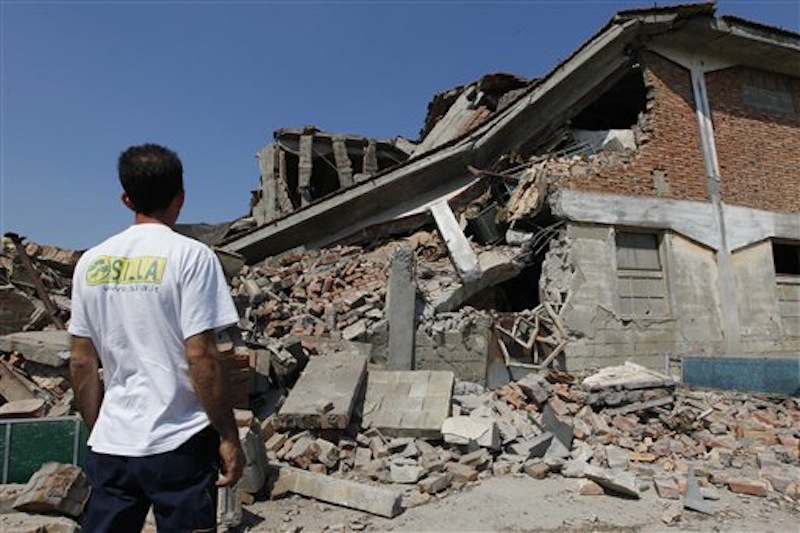 A man looks at a collapsed farm in Camposanto, northern Italy, Tuesday, May 29, 2012. A magnitude 5.8 earthquake struck the same area of northern Italy stricken by another fatal tremor on May 20. (AP Photo/Luca Bruno)