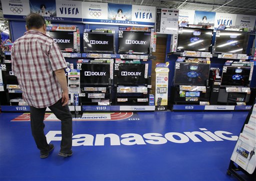 A man looks at a line of Panasonic TV products at an electric store in Tokyo today. Panasonic Corp.'s January-March losses ballooned 10-fold, completing a year of record red ink at the Japanese electronics maker battered by natural disasters and an ailing TV business.