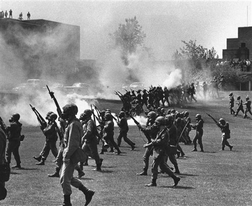 In this May 4, 1970, photo, Ohio National Guard troops move in on rioting students at Kent State University in Kent, Ohio. Four people were killed and 11 wounded when the Guardsmen opened fire.