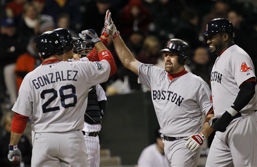 Boston Red Sox's Kevin Youkilis, center, celebrates a grand slam Thursday, April 26, 2012, in Chicago. Youkilis has been activated off the 15-day disabled list. (AP Photo/Charles Rex Arbogast)