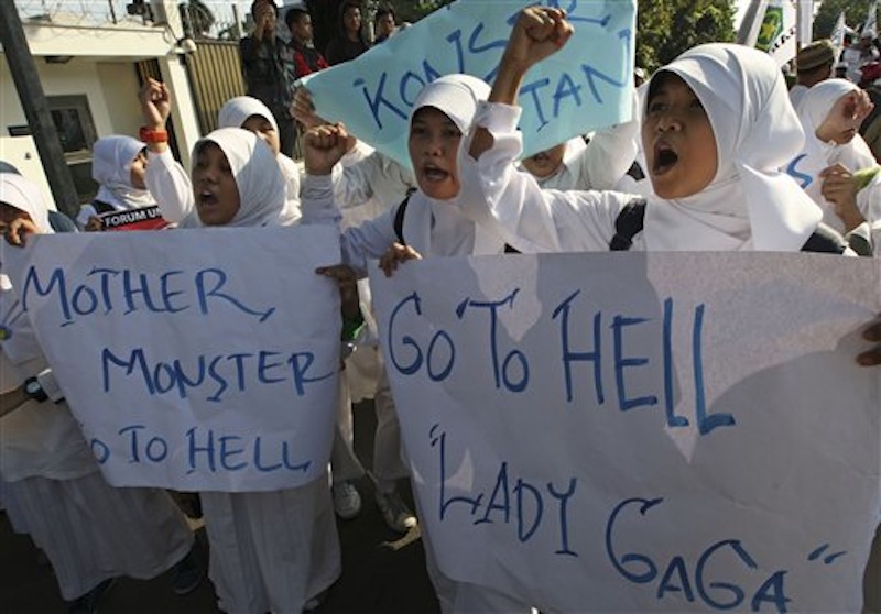 Muslim students shout slogans during a rally against U.S. pop singer Lady Gaga's concert that is scheduled to be held on June 3, outside the U.S. Embassy in Jakarta, Indonesia, Friday, May 25, 2012. Lady Gaga might have to cancel her sold-out show in Indonesia because police worry her sexy clothes and dance moves undermine Islamic values and will corrupt the country's youth. (AP Photo/Dita Alangkara)