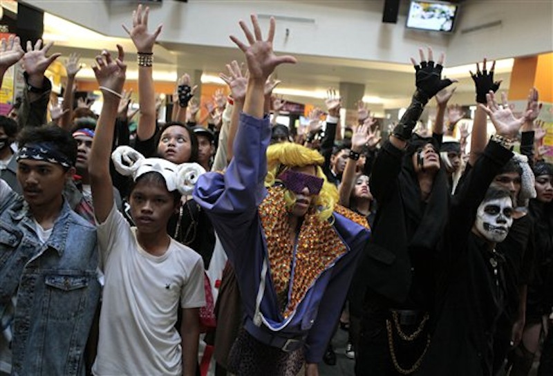 Fans of U.S. pop star Lady Gaga perform a flash mob at a shopping mall in Jakarta, Indonesia, Sunday, May 27, 2012. Lady Gaga canceled her sold-out show in Indonesia after Islamist hard-liners threatened violence, claiming her sexy clothes and provocative dance moves would corrupt the youth. (AP Photo/Dita Alangkara)
