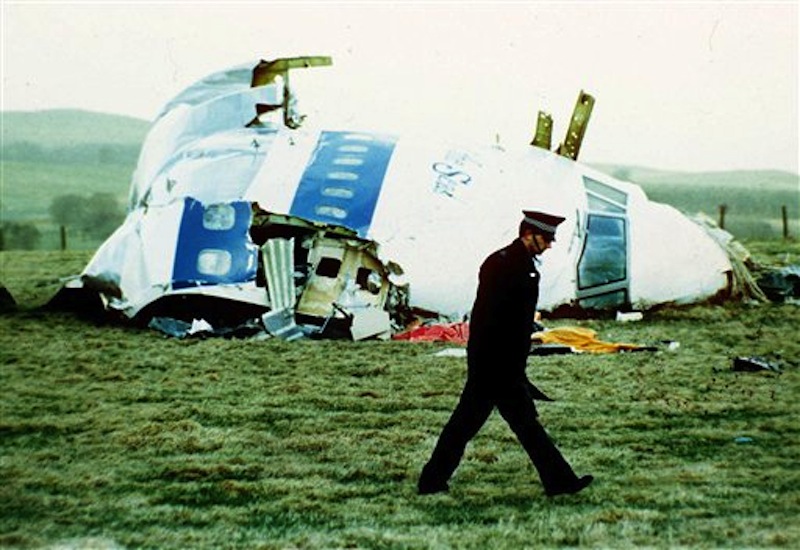 A police officer walks by the nose of Pan Am flight 103 in a field near the town of Lockerbie, Scotland where it lay after a bomb aboard exploded, killing a total of 270 people, in this December 21, 1988 file photo. The son of the former Libyan intelligence officer convicted of the bombing says his father has died. Abdel Baset al-Megrahi was released in 2009 from his Scottish prison on humanitarian grounds. Al-Megrahi suffered from prostate cancer. His death was announced on Sunday May 20 2012 by his son, Khaled. (AP Photo/Martin Cleaver, File)