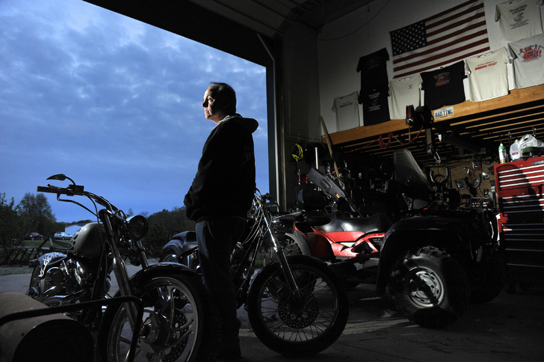 Rick Doyle stands next to his 2005 Venom Pro Street Big Bear Chopper, left, and 2004 Custom Chrome Nemesis in Hamersville, Ohio. Doyle, who used to own an aftermarket motorcycle parts dealership called the Hog Farm, and his wife, Tanya, worry that millions of problem parts are still on the roads.