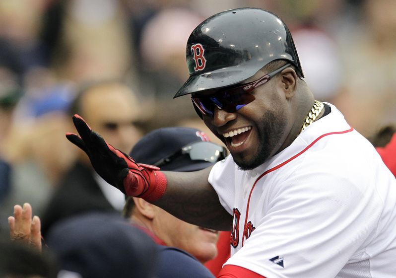 Boston Red Sox designated hitter David Ortiz celebrates as he returns to the dugout after scoring on a single by Will Middlebrooks in the fifth inning against the Seattle Mariners at Fenway Park in Boston today. Boston won 5-0.