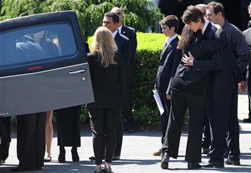 Members of Mary Richardson Kennedy's family embrace as the casket holding Kennedy, the estranged wife of Robert F. Kennedy Jr., arrives at St. Patrick's Church in Bedford, N.Y. Saturday, May 19, 2012. Kennedy was found dead of an apparent suicide this week at her home in Bedford. (AP Photo/Craig Ruttle)