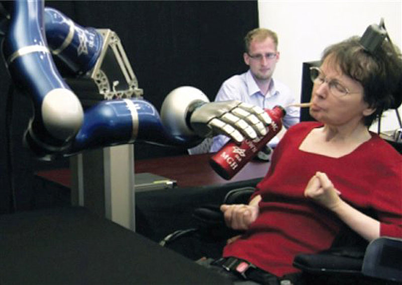 In this April 12, 2011 image from video provided by braingate2.org, Cathy Hutchinson of East Taunton, Mass. sips a drink held by a robotic arm during a test at a long-term care residence for adults with neurological disease in Dorchester, Mass. A report by researchers published in the Thursday, May 17, 2012 issue of the journal Nature describes how two people, paralyzed years before by strokes, were able to control free-standing robotic arms with the help of a tiny sensor planted in their brains. The sensor, about the size of a baby aspirin, eavesdropped on the electrical activity of a few dozen brain cells as the people imagined moving their arms. It then sent signals to a computer, which translated them into commands for the robot arms. (AP Photo/braingate2.org)