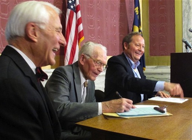 Montana Lt. Gov. John Bohlinger, left, former secretary of state Verner Bertelsen, center, and Gov. Brian Schweitzer on Thursday, May 3, 2012, show thier support for a proposed ballot initiative that says state policy is that corporations are not people and do not have constitutional rights, during a news conference in Helena, Mont. (AP Photo/Matt Gouras)