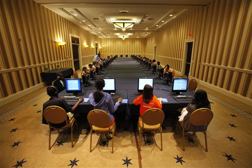 Contestants in the National Spelling Bee take the written exam on computers in Oxon Hill, Md., on Tuesday. The oral competition begins today.