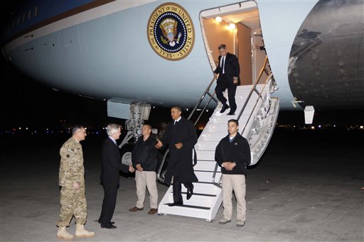 President Barack Obama is greeted by Lt. Gen. Curtis "Mike" Scaparrotti, left, and U.S. Ambassador to Afghanistan Ryan Crocker, second left, as he steps off Air Force One at Bagram Air Field in Afghanistan today.