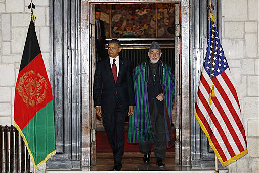President Barack Obama and Afghan President Hamid Karzai arrive at the presidential palace in Kabul today.