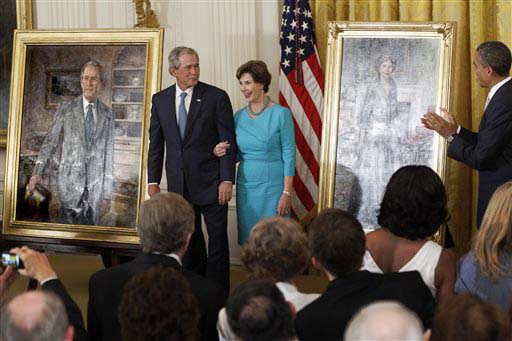 President Barack Obama applauds as former President George W. Bush and former first lady Laura Bush stand during the unveiling of their official portraits today.