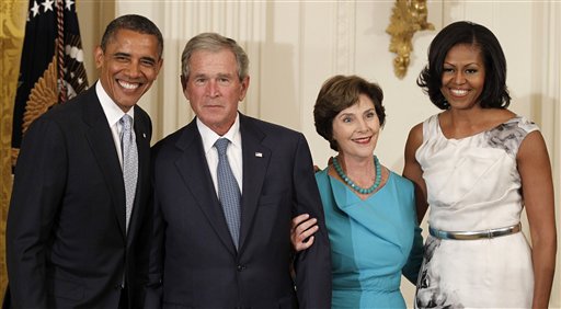 President Barack Obama, former President George W. Bush, former first lady Laura Bush and first lady Michelle Obama pose in the East Room of the White House today during a ceremony to unveil the Bushes' portraits.