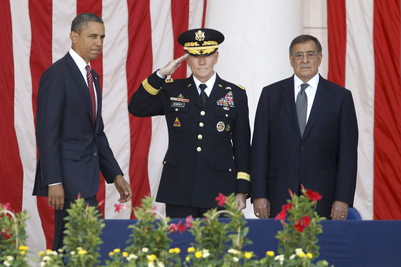 President Barack Obama arrives on stage at the Memorial Day Observance at the Memorial Amphitheater at Arlington National Cemetery, Monday, May 28, 2012. At center is Chairman of the Joint Chiefs of Staff Gen. Martin Dempsey and Defense Secretary Leon Panetta is at right.