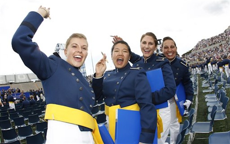 From left, cadets Anna Gault of Aurora, Ill., Linda Laui of Honolulu, Hi., Jamie Levesque of Orange County, Cal., and Kira A. Gonzalez of Kansas City, Ks., smoke cigars after the graduation ceremony at the United States Air Force Academy in Air Force Academy, Colo., on Wednesday, May 23, 2012. President Barack Obama declared Wednesday the world has a "new feeling about America" and more respect for its leadership, weaving re-election themes into a commencement speech to jubilant graduates of the U.S. Air Force Academy. (AP Photo/David Zalubowski)