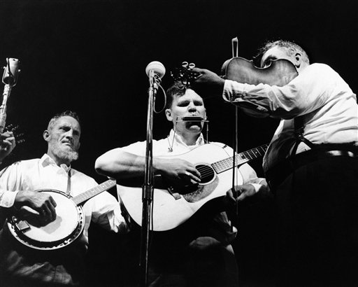 In this July 24, 1963, photo, Doc Watson, center, performs with the Watson Family on the opening night of the Newport Folk Festival in Newport, R.I.