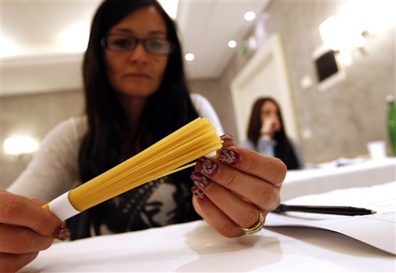 A woman touches pasta in a hotel conference room in Rome, Friday, May 18, 2012. Pasta sales worldwide have grown steadily over the past three years. Pasta is serious business in Italy, and the recent blind taste test organized by the world's biggest pasta maker, Barilla, drove home that an awful lot of thought goes into making the simple combination of durum wheat semolina and water from which Italy's national dish is made. (AP Photo/Alessandra Tarantino)