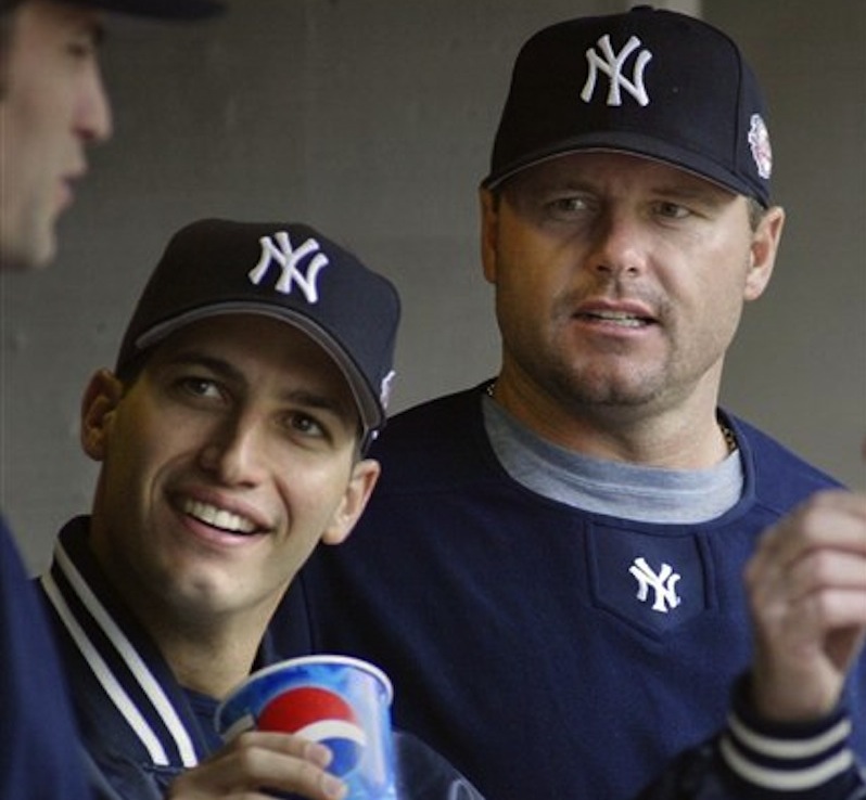 This May 31, 2003 file photo shows New York Yankees pitchers Andy Pettitte, left, and Roger Clemens talking with a teammate during a baseball game against the Detroit Tigers, in Detroit. Pettitte took the stand Tuesday in the Clemens perjury trial to testify against his former teammate. (AP Photo/Duane Burleson, File)