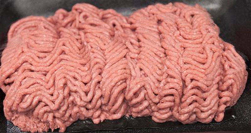 In this March 29, 2012 file photo, the beef product known as lean finely textured beef, or "pink slime," is displayed during a plant tour of Beef Products Inc. in South Sioux City, Neb., where the product is made. Gerald Zirnstein, the microbiologist who coined the term "pink slime," says it came to him in the spur of the moment as he was composing an email to a coworker at the U.S. Department of Agriculture a decade ago. Although it's been used as a filler for decades, the product became the center of controversy only after Zirnstein's vivid moniker for it was quoted in a 2009 New York Times article on the safety of meat processing methods. (AP Photo/Nati Harnik, File)