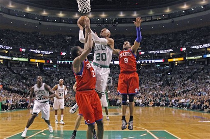 Boston Celtics' Ray Allen (20) drives past Philadelphia 76ers' Andre Iguodala (9)and over 76ers Thaddeus Young during the second quarter of Game 5 in their NBA basketball Eastern Conference semifinal playoff series in Boston, Monday, May 21, 2012. (AP Photo/Charles Krupa)