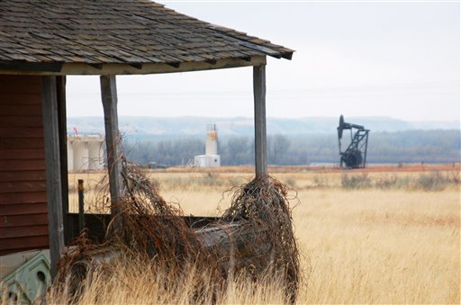 A nodding donkey pump extracts oil from the earth at an abandoned farm near the old ghost town of Dore, N.D. Dore has seen a rebirth with the booming oil activity in western North Dakota.