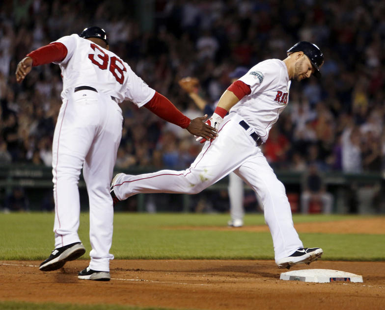 Red Sox first base coach Alex Ochoa reaches out to Cody Ross as he rounds the bases on a solo home run in the sixth inning Saturday.