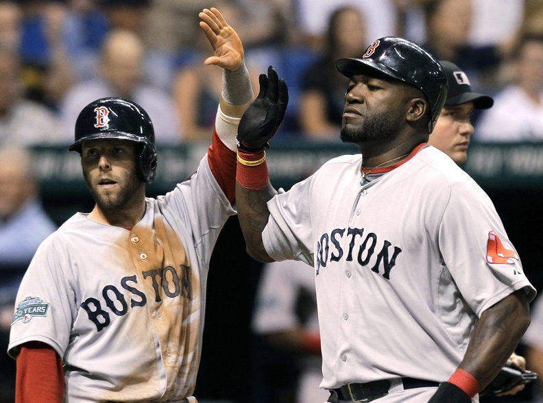 Boston's Dustin Pedroia and David Ortiz celebrate after scoring on an eighth-inning single by teammate Cody Ross off Tampa Bay Rays relief pitcher J.P. Howell on Thursday in St. Petersburg, Fla. The Red Sox won, 5-3.