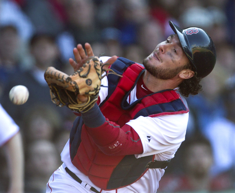 Red Sox catcher Jarrod Saltalamacchia is unable to get his glove on a foul ball hit by the Orioles' Adam Jones at Fenway Park on Sunday. The Red Sox gave up three runs in the 17th inning and lost 9-6.