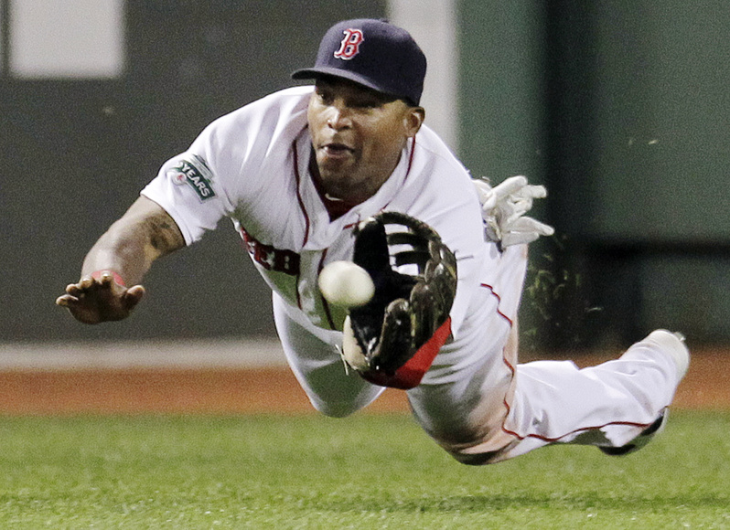 Boston Red Sox center fielder Marlon Byrd dives to catch a fly ball by Detroit Tigers' Gerald Laird during the eighth inning of the game at Fenway Park in Boston on Wednesday. The Red Sox won 6-4.