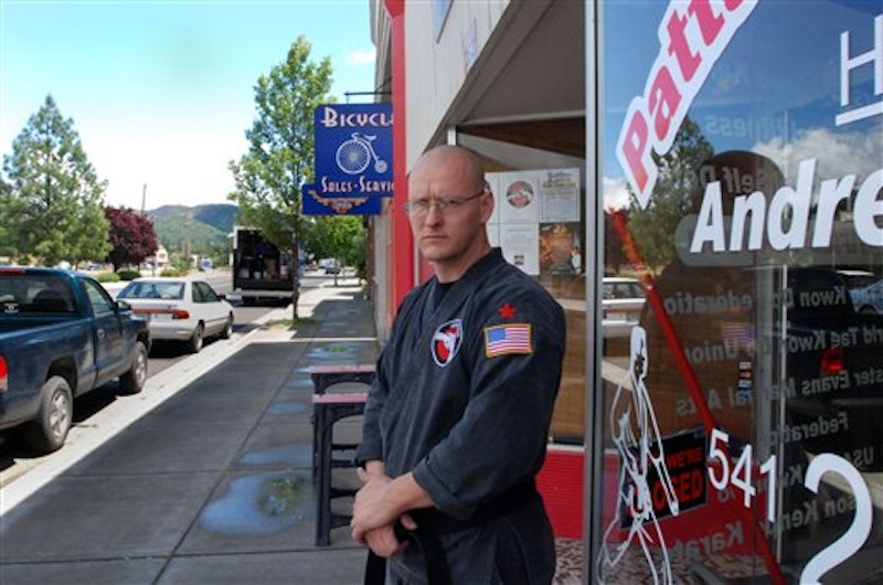 Andrew Lee Patterson stands Thursday, May 24, 2012 outside his karate studio in Gold Hill, Ore. Patterson says he no longer wants to be known for the violence and white supremacist beliefs that sent him to prison and led him to lead a chapter of the neo-Nazi National Socialist Movement. But a city councilor in Gold Hill wants people to know about his past before deciding to entrust their children to his teaching. (AP Photo/Jeff Barnard)