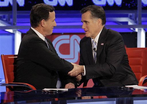 Republican presidential candidate Mitt Romney, right, talks with former Pennsylvania Sen. Rick Santorum after a presidential debate in Arizona in this Feb. 22, 2012, photo.