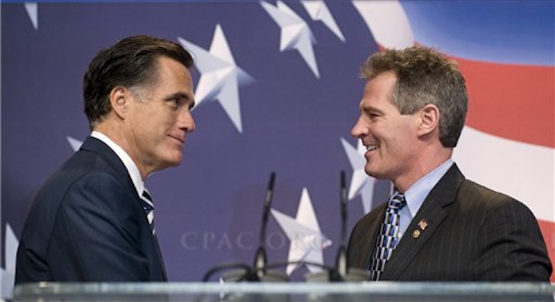 In this Feb. 18, 2010, file photo former Massachusetts Gov. Mitt Romney, left, is announced by Sen. Scott Brown, R, Mass., as he arrives on stage to speak at the Conservative Political Action Conference in Washington. The two Massachusetts Republicans have a history of supporting each other throughout their political careers, but facing tough elections neither is the presidential candidate nor the U.S. senator is playing up that history now, perhaps with good reason. (AP Photo/Cliff Owen, File)