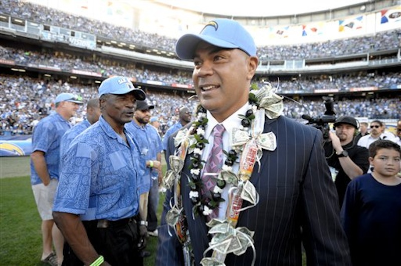 In this Nov. 27, 2011 file photo, former San Diego Chargers great Junior Seau smiles during his induction into the Chargers Hall of Fame during a halftime ceremony of an NFL football game in San Diego. Police say Seau, a former NFL star, was found dead at his home in Oceanside, Calif., Wednesday, May 2, 2012, after responding to a shooting there. He was 43. (AP Photo/Denis Poroy, File)
