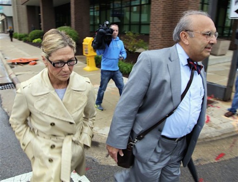 Rita Crundwell, former comptroller for Dixon, Ill., leaves federal court in Rockford, Ill., Monday, May 7, 2012, with her attorney Paul Gaziano, after pleading not guilty at her arraignment to charges that accuse her of stealing tens of millions of dollars from the community. Prosecutors contend that Crundwell had been transferring Dixon's money to a secret account since at 1990 and using the money to create one of the nation's leading horse-breeding operations and buy luxury homes, cars and jewelry. (AP Photo/Robert Ray)