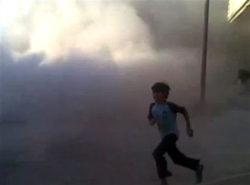 This frame grab made from an amateur video provided by Syrian activists on Monday, May 28, 2012, purports to show the massacre in Houla on May 25 that killed more than 100 people, many of them children. The amateur footage shows people running along a street, purportedly just after the attack on Houla started. (AP Photo/Amateur Video via AP video)