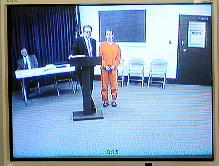 In this photo of a video screen in the office of Maine District Court Justice Donald Alexander, Kristina Lowe, 19, appears via video uplink from the Oxford County Jail in Paris. She faces two manslaughter charges in connection with a fatal car crash that happened while police say she was texting back and forth with friends at an underage drinking party.