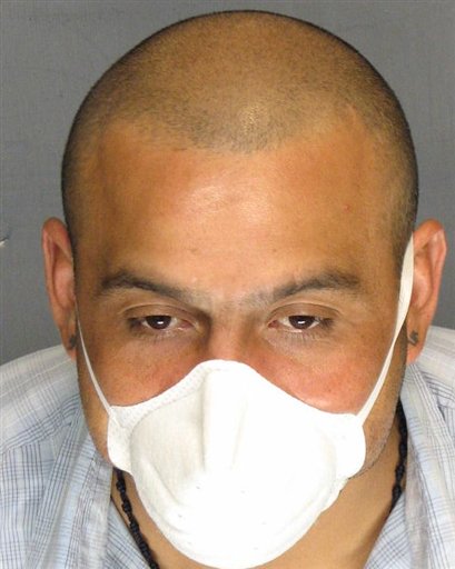 In this undated photo supplied by the San Joaquin County District Attorney's office, Armando Rodriguez is seen wearing a protective mask. Prosecutors say 34-year-old Armando Rodriguez, a tuberculosis patient, has been arrested for refusing to take his medication and missing doctor appointments, and is endangering public health by not treating the airborne disease.