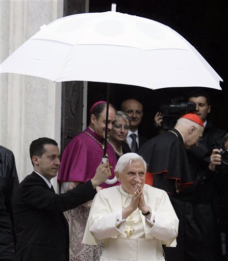 In this May 17, 2008, file photo, Pope Benedict XVI's butler, Paolo Gabriele, left, holds an umbrella for the pontiff as Benedict arrives at a shrine in Savona, Italy. Gabriele, arrested for allegedly having confidential Vatican documents in his home, has agreed to cooperate with investigators.