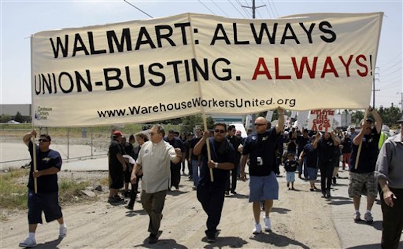 In this Thursday, May 14, 2009 file photo, about 100 demonstrators march down a highway as union organizers, clergy, students and others demonstrate at a Wal-Mart distribution center in Fontana, Calif. For years, the world's largest retailer has tried to repair a reputation that's been damaged by decades of criticism and legal troubles. In April 2012, allegations that Wal-Mart paid bribes to officials in Mexico threaten to derail Wal-Mart's attempts to improve its image. (AP Photo/Reed Saxon)