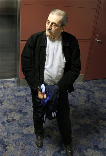 Dejan Radojkovic, 61, arrives at McCarran Airport in Las Vegas, for the initial leg of his removal flight back to Sarajevo. The Associated Press photo