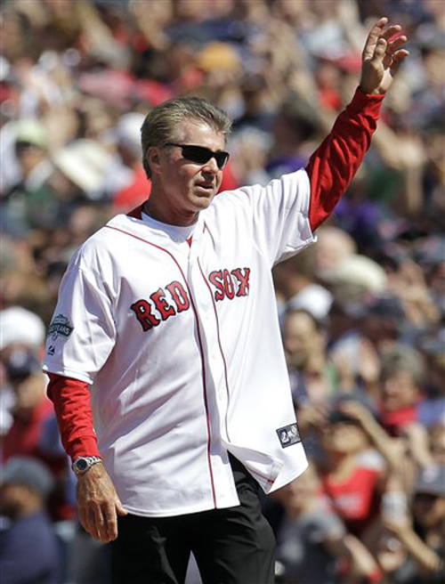 Former Boston Red Sox first baseman Bill Buckner waves to cheering fans at Fenway Park in Boston on April 20, 2012, during a celebration of the 100th anniversary of the first regular-season game at Fenway Park.