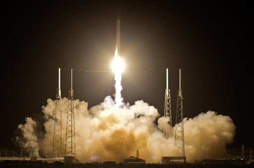 The Falcon 9 SpaceX rocket lifts off from space launch complex 40 at the Cape Canaveral Air Force Station in Cape Canaveral, Fla., early Tuesday, May 22, 2012. This launch marks the first time, a private company sends its own rocket to deliver supplies to the International Space Station.(AP Photo/John Raoux)