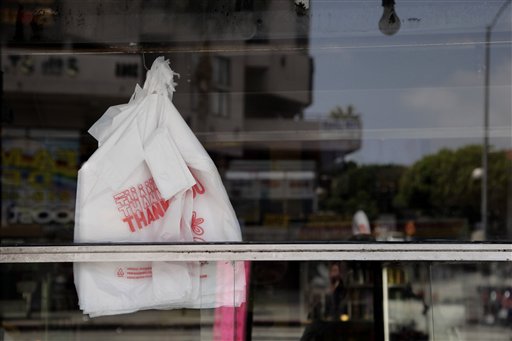 Plastic bags are seen through the window of a restaurant in Los Angeles, Thursday, May 24, 2012. Now that the city of Los Angeles has taken the first step toward banning plastic bags, it appears the little utilitarian bags themselves may be headed for the trash heap of history. (AP Photo/Jae C. Hong)