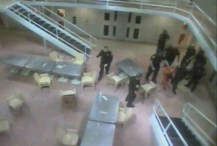 A screen image from a video provided by the Maine ACLU that purportedly shows Wilmer Moreno Recinos being led away after being beaten by Cumberland County jail guards.