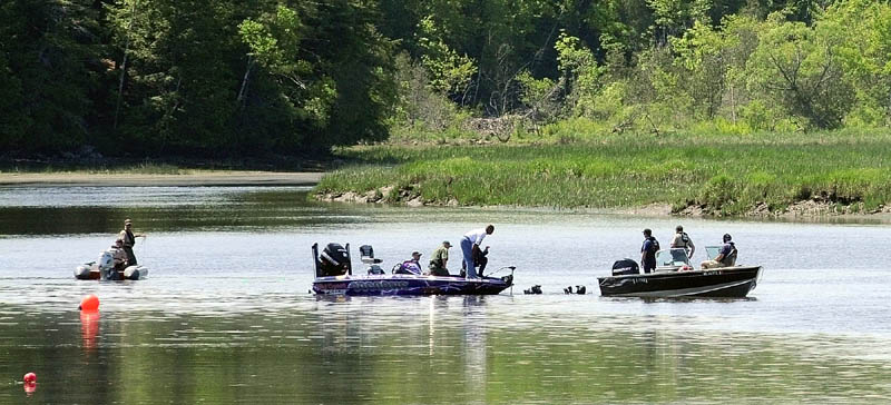 Divers in the water talk to other searchers on boats this morning on the Cathance River in Bowdoinham as they try to find for Santana Dubon, 32, of Portland. He was in a canoe with two family members when the canoe capsized around 7:30 p.m. Saturday evening, according to Sgt. Daniel White of the marine patrol. The two others made it to shore safely, but Dubon has not been found.