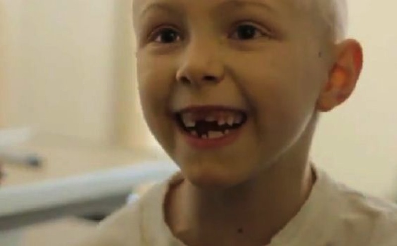 This image shows one of the cancer-stricken kids singing Kelly Clarkson's "Stronger" in a new music video.