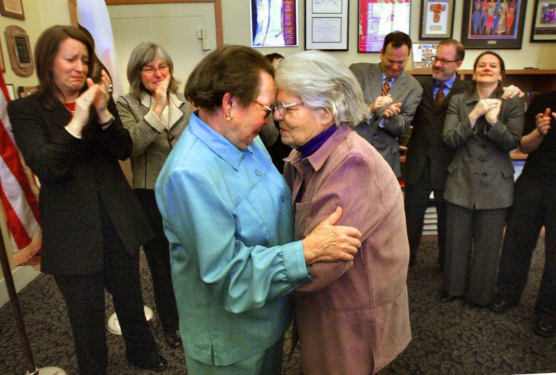 Longtime gay activists Phyllis Lyon, left, and Del Martin embrace in front of San Francisco City Hall after being married Feb. 12, 2004.