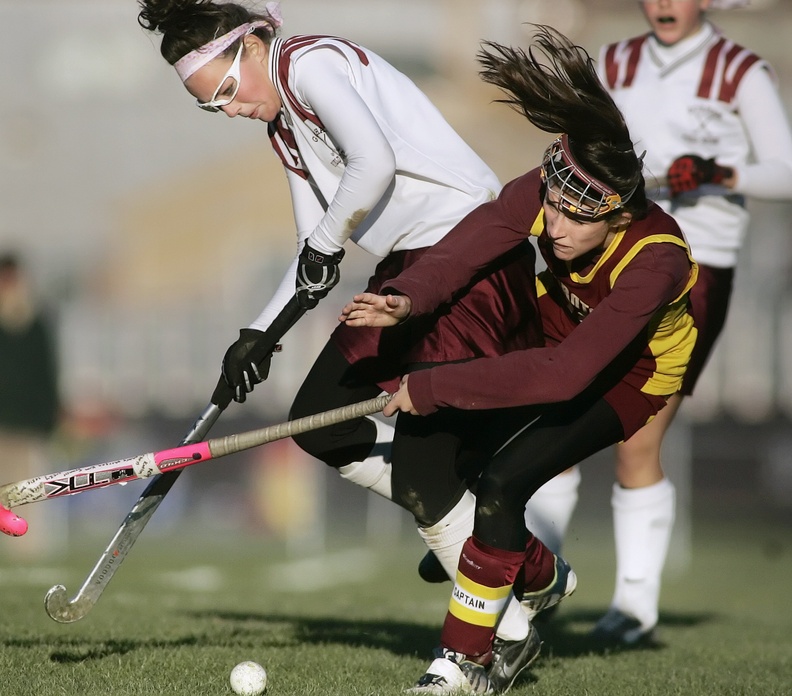 Kelly Van Clief of Thornton Academy, right, collides with Kayleigh Ballantyne of Gorham during a game in 2008. Some coaches say wearing goggles increases the risk of collisions because it restricts a player’s vision.