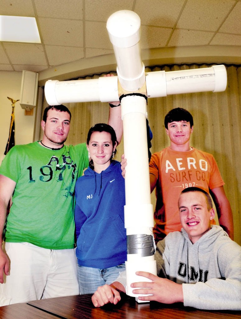 THE BEAST: Madison Area Memorial High School students hold their project called the "Floating Beast" a scale model offshore, floating, wind-turbine platform. From left are Travis Emerson, Jess Thebarge, Matt Soucy and Stephan Cusson, seated.