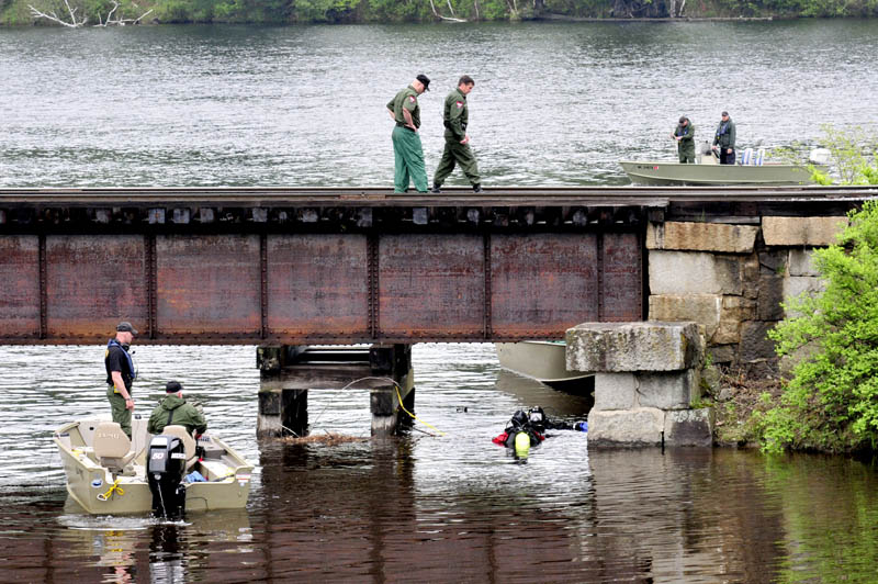 INCH BY INCH: On Tuesday game wardens and divers search the site where Martin Stream enters the Kennebec River in Hinckley a short distance from where missing driver Cora Marley left the roadway and crashed her car on a nearby bridge last Saturday.
